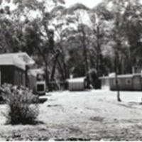 Old blurry image of buildings in the bush