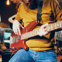 A person strumming an electric guitar