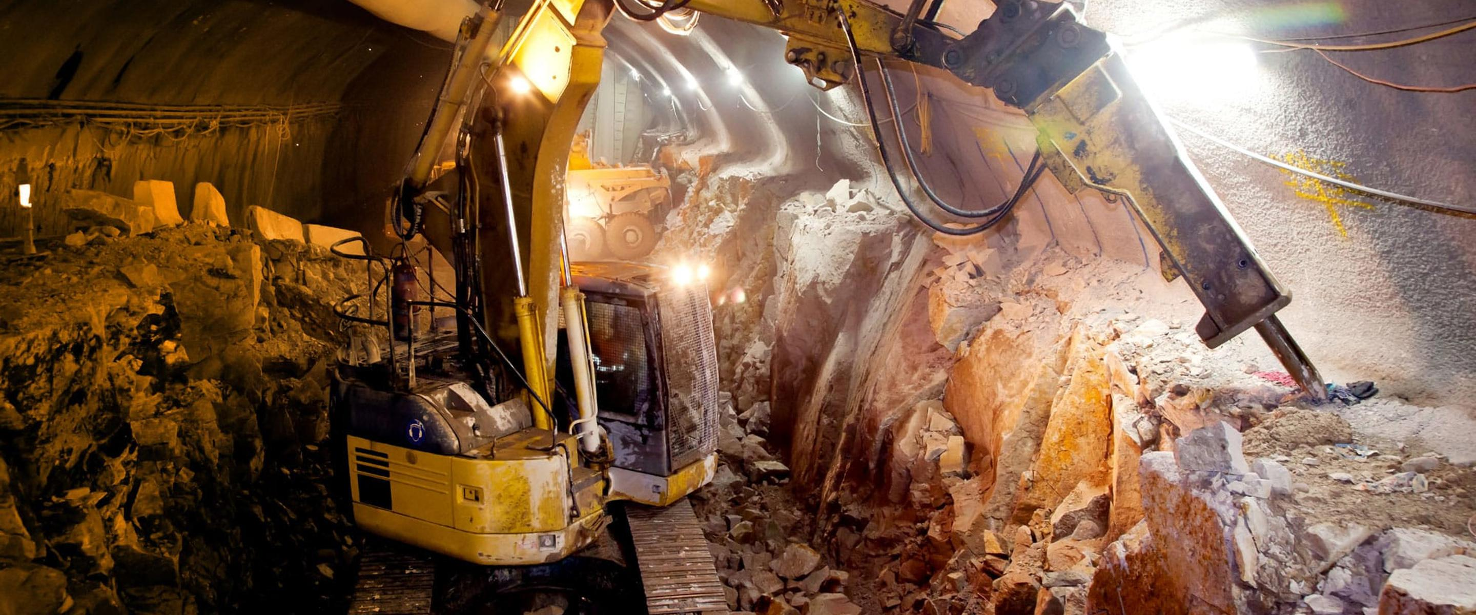 Heavy vehicle machinery inside a tunnel drilling to create room