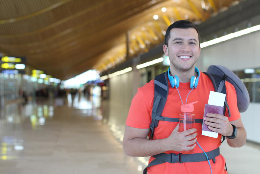 A traveling student holding his passport