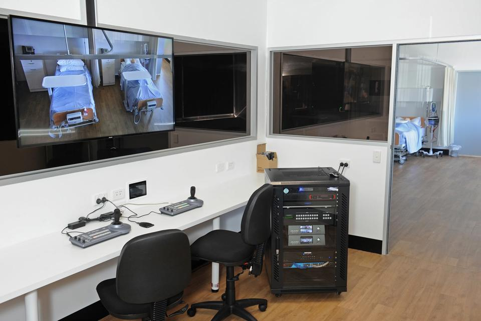 Study purpose built sample hospital room with monitoring work station with screen and computer system