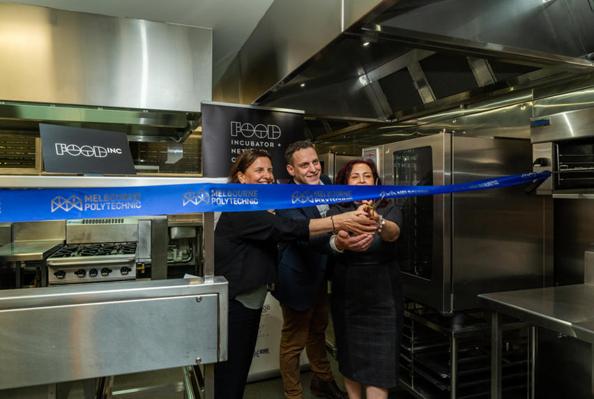 Frances Coppolillo (CE of Melbourne Polytechnic) David Williamson (CEO Melbourne Innovation Centre) and Cr Lina Messina (Mayor of the City of Darebin) cutting ribbon in training kitchen to launch FoodINC